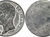 a close up of a coin on a white surface