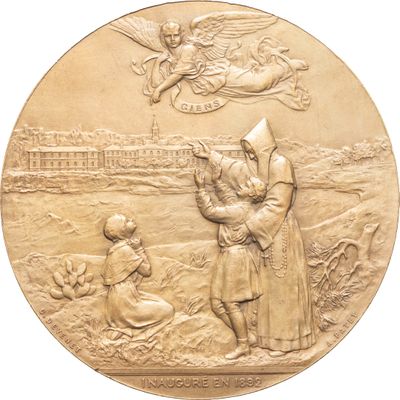 une image représentant une médaille d'or sur laquelle figurent un saint et un enfant