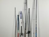 many different fishing rods lined up against a wall