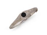 a close up of a ring with a black stone on it