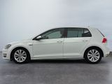 the white volkswagen golf is parked in a parking lot