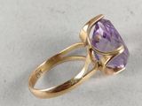 a close up of a gold ring with an amethorate stone