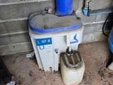 a water tank with a blue lid next to a blue and white tank