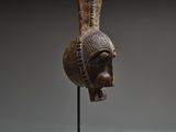 an image of a wooden sculpture of a head on a stand