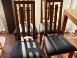 four chairs sitting in front of a window on a tiled floor