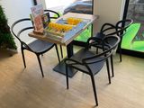 a table with four chairs and a board game on it