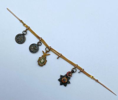 a close up of a gold bracelet with charms on it