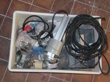 a white container filled with electrical equipment on a tiled floor