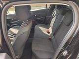 the back seats of a car with a bottle of soda in it