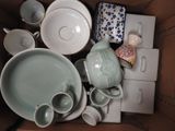 a box full of tea cups and saucers in it