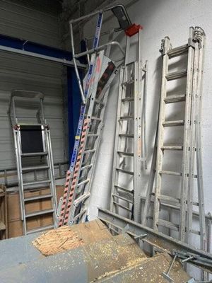 many ladders that are leaning up against a wall