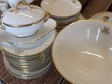 a lot of plates and bowls on the table