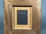 an old picture frame with a picture of a person in it