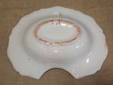 a white plate with a gold ring on top of it