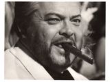 black and white photograph of a man with a beard smoking a cigar