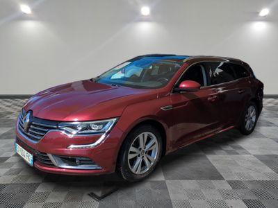 a red volkswagen passat is parked in a room with a checkered floor