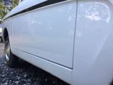 a white car that is parked on the side of the road