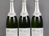 three bottles of champagne sitting on top of a table next to each other