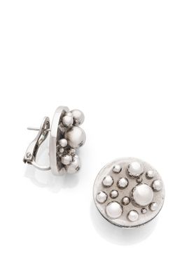 a close up of a pair of earrings on a white surface