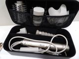 a hair dryer and brush in a case on a table