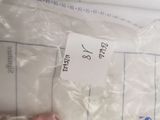 a person holding a piece of paper that has a price tag on it
