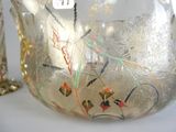 a glass vase that has been decorated with flowers and birds