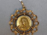a close up of a gold medal with a picture of a woman on it