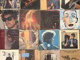 a lot of records on the wall of a room