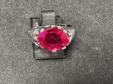 Gros plan sur une bague contenant une pierre rouge