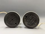 two black and white electrical plugs sitting on top of each other