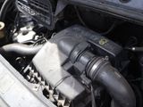a close up of a car ' s engine with its hood open