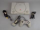 a video game console with two controllers and a charger