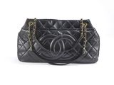 a chanel black quilted leather handbag with gold chain handles