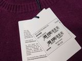 purple sweater with bar code tag attached to it on a hanger