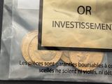 a sign that says or investissement on the front of a bag of coins