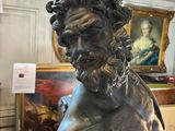 a statue of a man with a beard sitting on a table