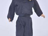a doll of a man with a mustache on a white surface