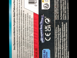 a close up of a package of toothpaste on a black background