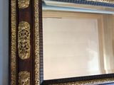 a picture of a mirror hanging on the wall