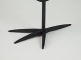 a black candle holder on a white table