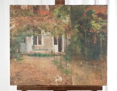 a painting on a easel with a painting of a house in the background
