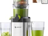a blender that is sitting next to a glass of juice