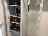 an image of a refrigerator in a room with a lot of bottles