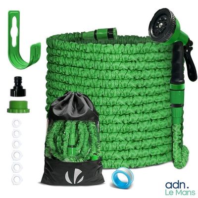 le tuyau vert se trouve à côté d'un sac d'eau et d'un arroseur