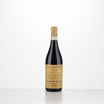 a bottle of red wine sitting on top of a table
