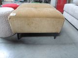 a couch and ottoman in a store with a price tag on it