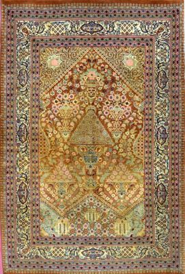 an antique persian rug with a medallion design on a pink ground
