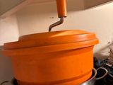 pots and pans are stacked on top of each other in a kitchen