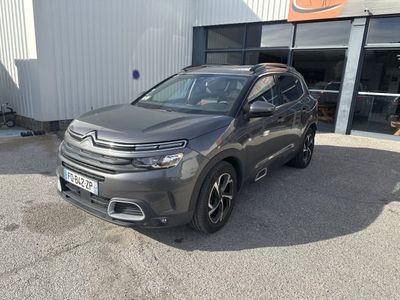 une citrole grise garée devant un immeuble