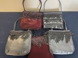 four small purses are lined up on a blue surface
